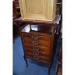 AN EDWARDIAN MAHOGANY FIVE DRAWER MUSIC CABINET with a wavy galleried top (sd, losses)