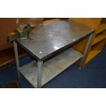 A STAINLESS STEEL WORK BENCH/TABLE, with table top vice