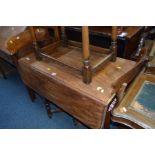 A GEORGIAN MAHOGANY DROP LEAF TABLE standing on a turned pedestal with four carved legs