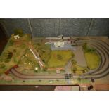 A 00 GAUGE MODEL RAILWAY LAYOUT, large double track oval with three sidings, laid on a chipboard