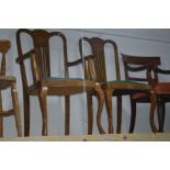 AN EARLY 20TH CENTURY OAK SPLAT BACK CARVER CHAIR and a matching chair with a different seat pad (