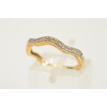 A 9CT GOLD DIAMOND SET HALF ETERNITY RING, the wave shape set with single cut diamonds, estimated