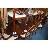 A REPRODUCTION MAHOGANY OVAL TOPPED TWIN PEDESTAL DINING TABLE with one additional leaf, extended
