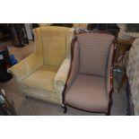 AN EDWARDIAN MAHOGANY FRAMED ARMCHAIR together with an early 20th century yellow upholstered wing