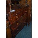 A GEORGIAN CROSS BANDED MAHOGANY CHEST of two short over two long drawers with turned handles and
