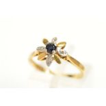 AN 18CT GOLD SAPPHIRE AND DIAMOND FLOWER RING, designed as a central claw set circular sapphire,