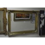 A MODERN GILT FRAMED BEVELLED EDGE WALL MIRROR, 91cm x 65cm together with three other wall mirrors