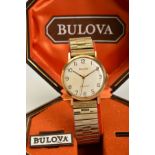 A BOXED 1970'S 9CT GOLD CASED BULOVA LONGCHAMP WRISTWATCH, silvered dial with Arabic markers, hand