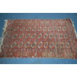 A LATE 19TH CENTURY TEKKE RED GROUND RUG, 187cm x 110cm (sd, low pile, some repairs)