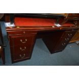 A REPRODUCTION MAHOGANY RED LEATHER TOPPED DESK with six drawers, together with a Bradley mahogany