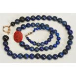 TWO SINGLE ROW LAPIS LAZULI BEAD NECKLACES, the first designed as a near uniform row of spherical
