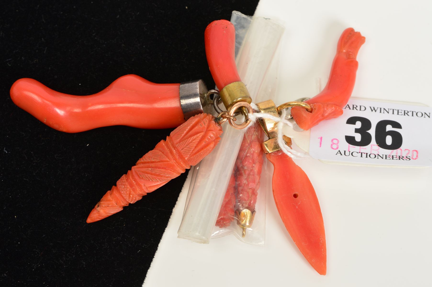 A SELECTION OF CORAL PENDANTS AND CARVED CORAL PIECES, to include a late 19th Century piece of coral