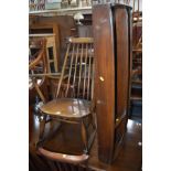 AN ERCOL DARK BEECHWOOD ROCKING CHAIR with spindle back and shaped top splat, a matching plate