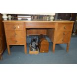 A MID 20TH CENTURY GOLDEN OAK DESK with six drawers, width 151cm x depth 84cm x height 77cm