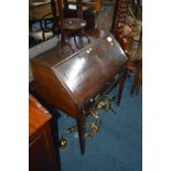 A GEORGIAN OAK FALL FRONT BUREAU with a fitted interior, single drawer on four square tapering legs,