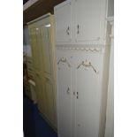 A CREAM THREE PIECE BEDROOM FITMENT, comprising of a double door wardrobe, dressing table and a