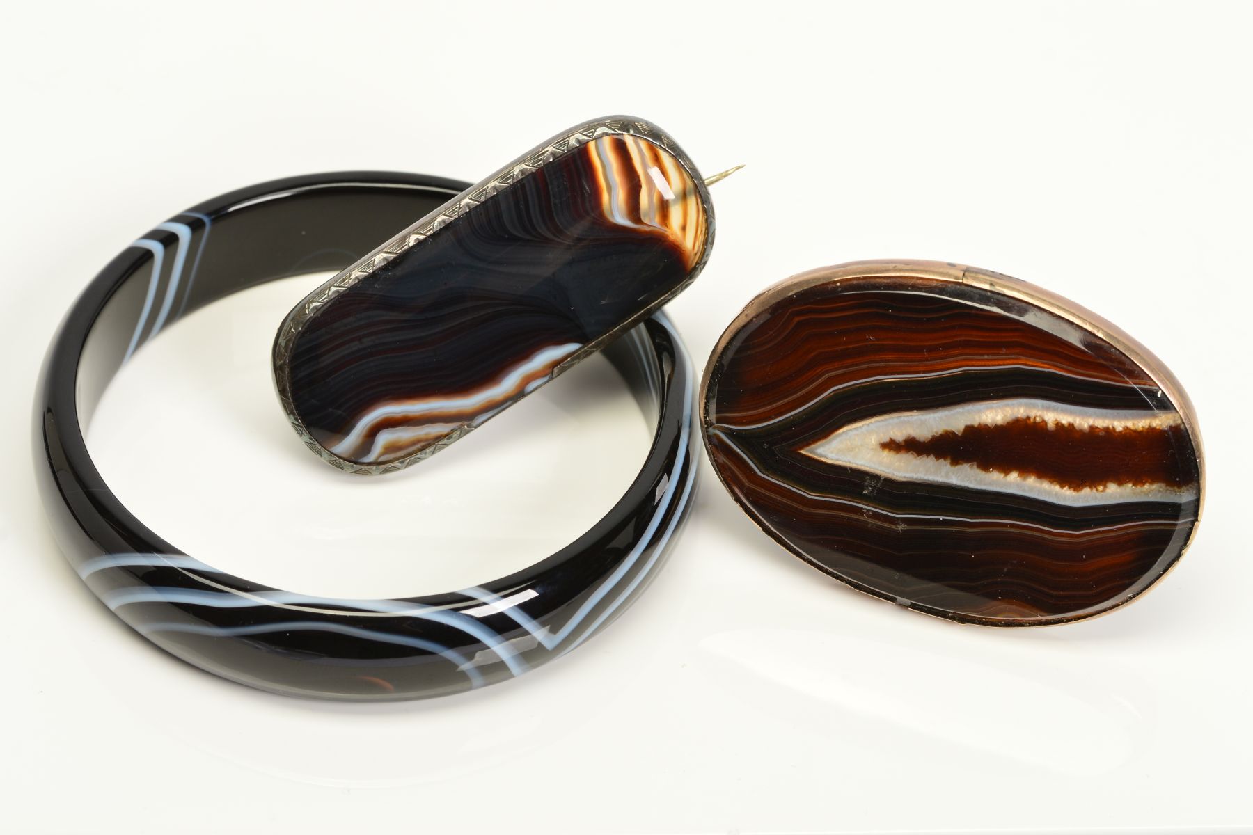 THREE PIECES OF BANDED AGATE JEWELLERY, to include a D shape banded agate bangle, inner diameter