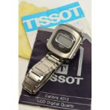 A RETRO TISSOT LCD WRISTWATCH, a cushion shaped plastic and metal case with a small rectangular