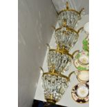 FOUR MID 20TH CENTURY WALL LIGHTS, each having decorative gilt metal frames, chandelier type