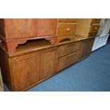 A MID CENTURY TEAK SIDEBOARD with two central drawers and two pairs of doors either side, width