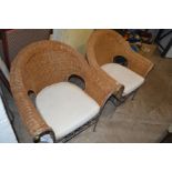 A PAIR OF STEEL FRAMED WICKER ARMCHAIRS
