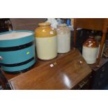 A COLLECTION OF FOUR EARTHENWARE JUGS AND JARS and a painted coopered barrel (converted)