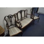 AN EDWARDIAN MAHOGANY SALON SUITE, with foliate decoration and spindled splat backs, comprising of a