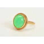 A 9CT GOLD GEM RING, designed as an oval chrysoprase cabochon within a collet and rope twist