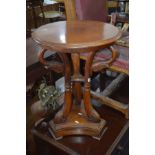 A REPRODUCTION HARDWOOD CIRCULAR TOPPED OCCASIONAL TABLE on triple swan neck supports