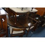 AN BERGERE ROCKING CHAIR, together with an oak circular drop leaf dining table, a set of four teak