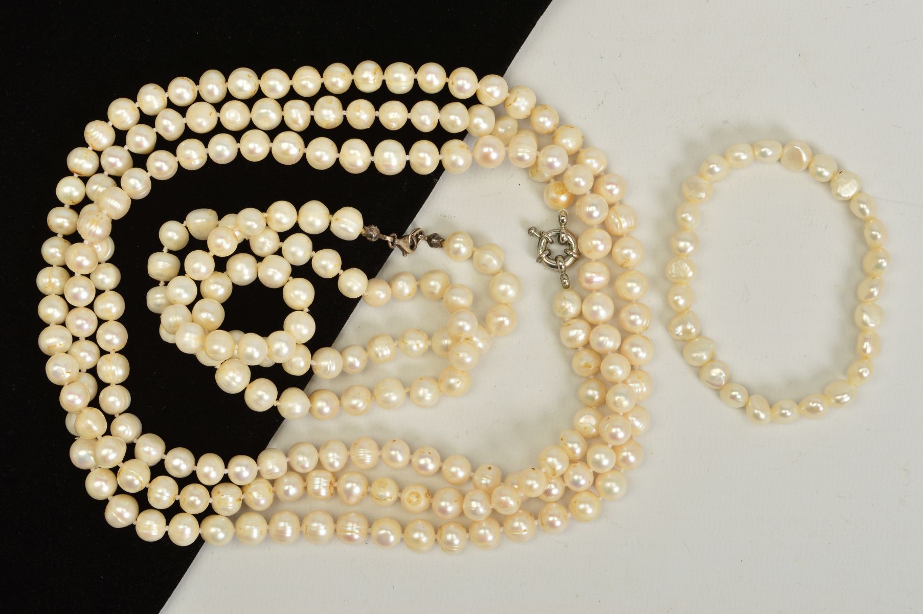 TWO CULTURED PEARL NECKLACES AND A SULTURED PEARL BRACELET, to include a long necklace, a further