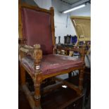 A DISTRESSED EARLY 20TH CENTURY OAK ECCLESIASTICAL ARMCHAIR