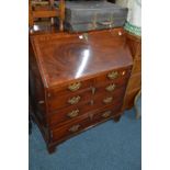 A GEORGIAN AND LATER MAHOGANY FALL FRONT BUREAU with pressed and detailed escutcheons and drop