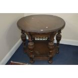 AN EARLY 20TH CENTURY OAK CIRCULAR TOPPED CENTRE TABLE, on a hexagonal base with a mask face