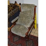 A LATE VICTORIAN WALNUT SCROLLED ARMCHAIR on ceramic casters (sd)