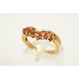 A 9CT GOLD GEM RING, the V-shape front set with a line of seven circular orange gems assessed as