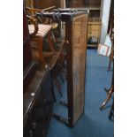 AN EARLY 20TH CENTURY OAK WINDOW SEAT, with a distressed wickerwork seat, width 145cm x depth 46cm x