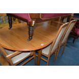 A MODERN TEAK EXTENDING DINING TABLE and six chairs including two carvers (7)