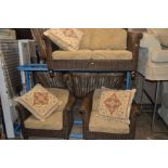 A DARK WICKER CONSERVATORY THREE PIECE SUITE comprising of a two seater settee and two armchairs,