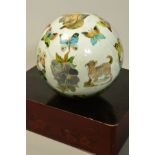 AN EARLY 20TH CENTURY DECALOMANIA GLASS BALL, decorated with animals and butterflies, approximate