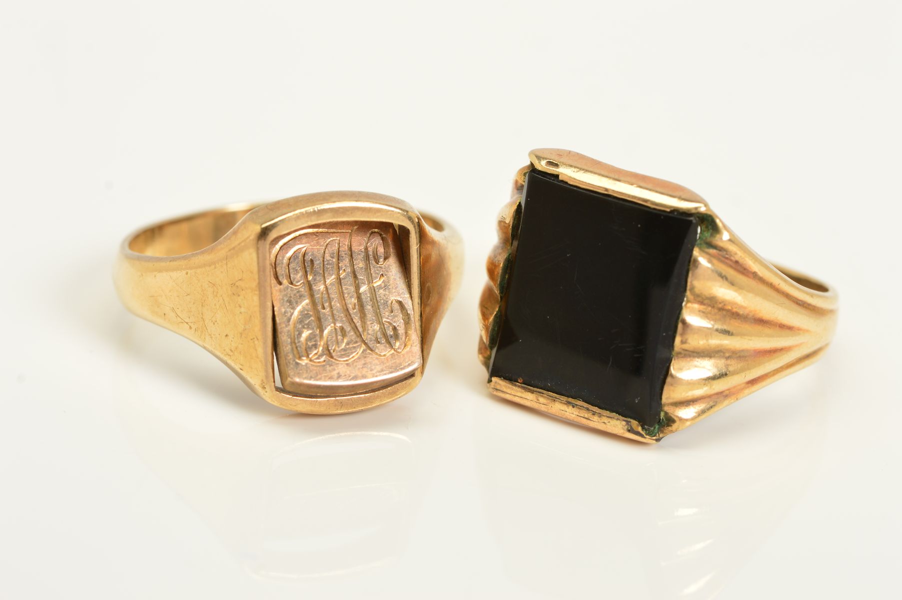 TWO GENTLEMAN'S RINGS, the first a 9ct gold ring, the central rectangular panel with engraved