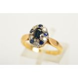 A SAPPHIRE AND DIAMOND RING, of tiered design featuring a central oval cut sapphire with a