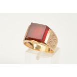 A 9CT GOLD CARNELIAN SIGNET RING, designed as a square carnelian panel to the tapered band with