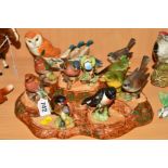 THIRTEEN BESWICK BIRDS AND A STAND, two Robins No980B (one missing beak), 'Chaffinch' No991B, two '