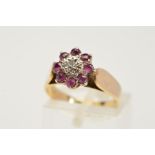 A 9CT GOLD RUBY AND DIAMOND CLUSTER RING, designed as a central single cut diamond within a star