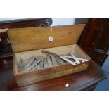 A VINTAGE PINE BOX containing cast iron Roman numeral golf markers