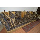A FOLIATE DECORATED BLUE AND GOLD UPHOLSTERED KNOLE TWO PIECE SUITE, with acorn wooden finials,