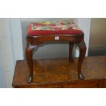 AN EARLY 20TH CENTURY GEORGIAN STYLE MAHOGANY SERPENTINE STOOL on cabriole legs with needlework