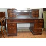 A VICTORIAN MAHOGANY DICKENS DESK, the top fitted a hinged sloped black leather top, flanked by