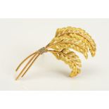A BROOCH, designed with three curved ferns, stamped 750, length approximately 67mm, approximate